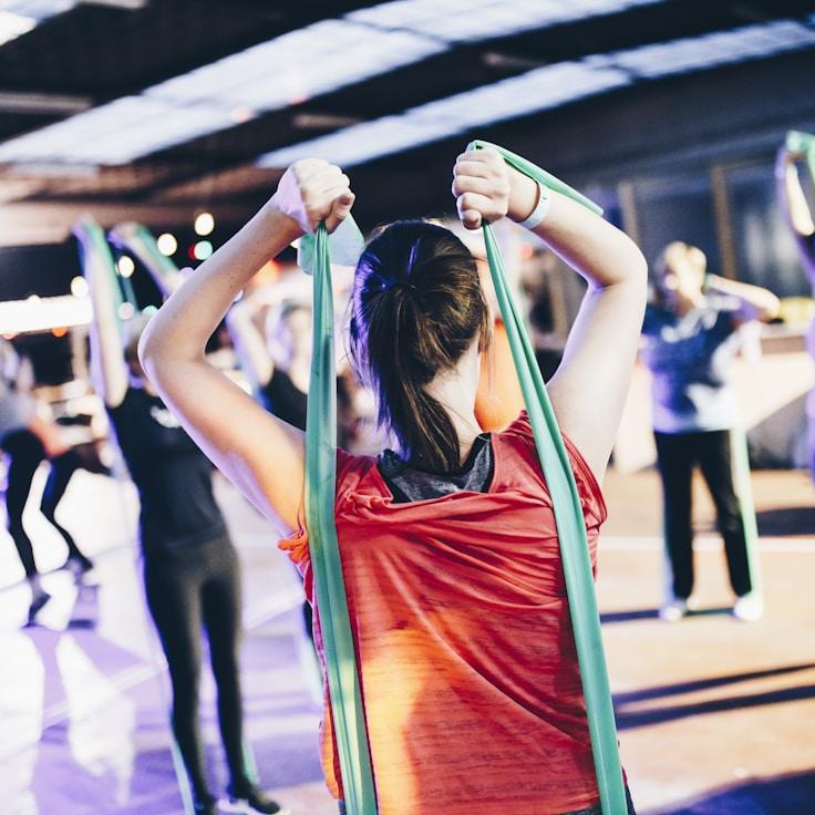 Women in a fitness class doing stretching and mobility exercises